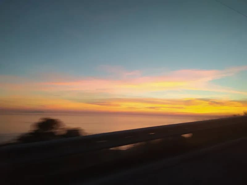 Sunset glowing orange and pink over the sea, seen from the Llogara area on the Albanian coast.