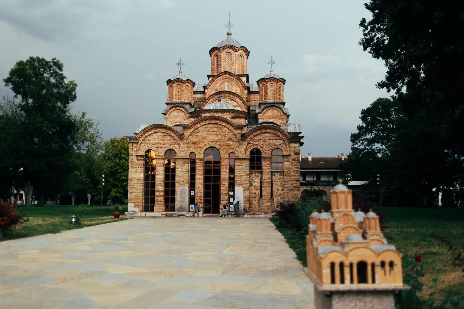 The church of Gračanica Monastery behind a small stone model of the building.